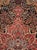 This early 20th-century Persian Sarouk room-size carpet presents a richly detailed central medallion composition in deep...