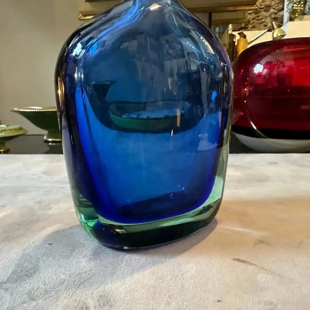 An elegant blue sommerso murano glass bottle vase designed in the Seventies by Flavio Poli and manufactured in Venice by...