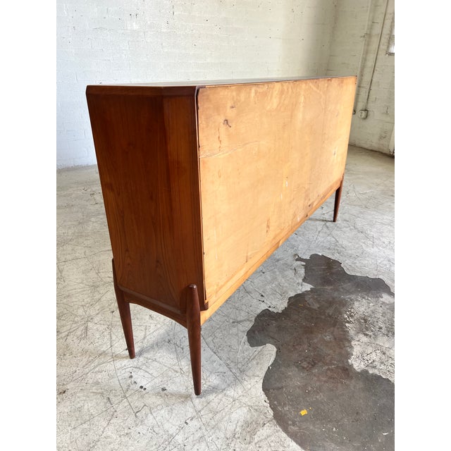 Extraordinary tall Danish teak credenza, featuring beautifully tapered legs, angled corners and plenty of storage...