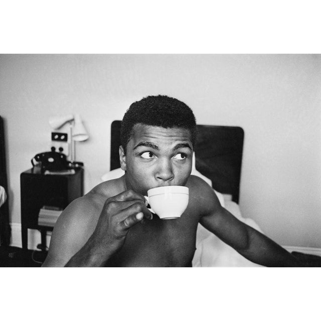 Cassius Clay In London American Heavyweight boxer, Cassius Clay (later Muhammad Ali, 1942 - 2016), relaxing his hotel...
