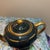 This elegant Art Deco-style teapot features a deep green glaze accented by stunning 22-karat gold-gilded filigree and...