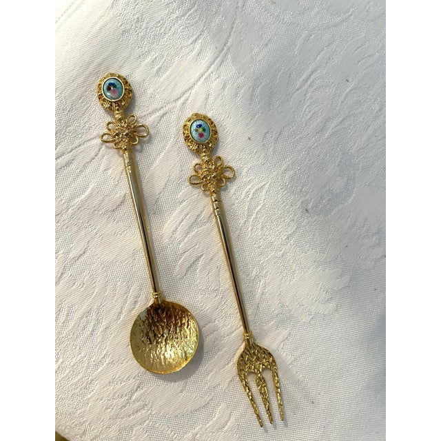 Elegant set of twelve, stainless steel, gold plated, ornate, appetizer forks and spoons each inset with a blue porcelain...