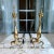Brass andirons or chenets with 22” tall vertical urn shape and topped finial. These chenets include a brass billet cap...