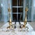 Brass andirons or chenets with 22” tall vertical urn shape and topped finial. These chenets include a brass billet cap...