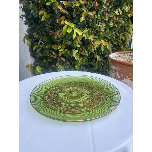Striking vintage mid-century glass platter featuring a rich emerald green base with raised concentric texture and ornate...