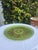 Striking vintage mid-century glass platter featuring a rich emerald green base with raised concentric texture and ornate...