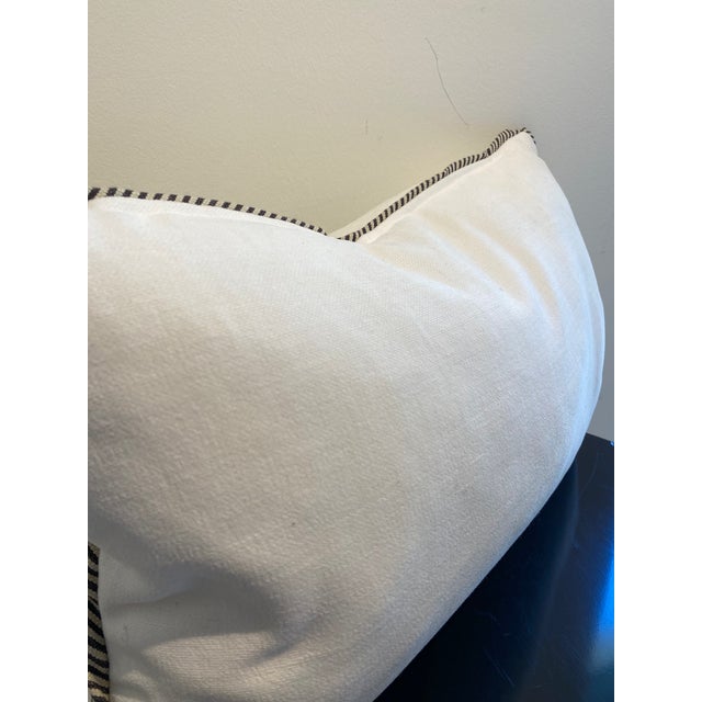 This lumbar pillow features a crisp, white textured fabric that adds a touch of sophisticated comfort to any seating area....
