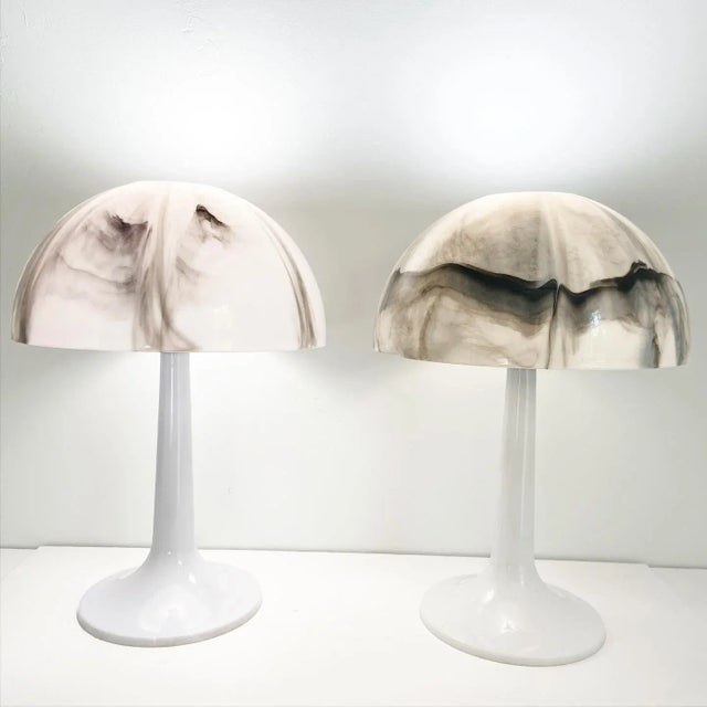 Chic pair of 1970s modern mushroom lamps by Gilbert with striking black, grey, and white marbled shades on molded plastic...