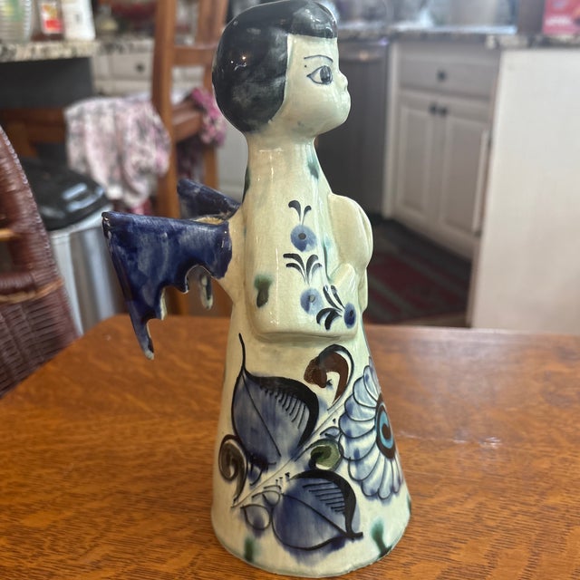 Tonala Candleholder in the shape of an angel. She is beautifully painted with a Tonala floral motif.