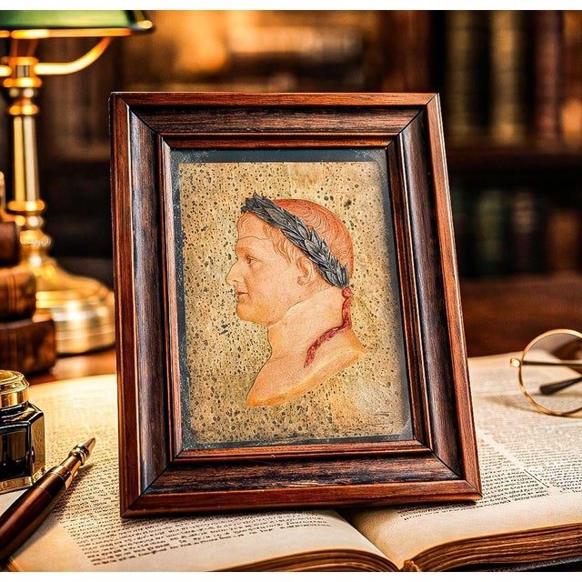 A truly charming and evocative 19th-century framed hand-painted wax profile of Napoleon, portrayed as a Roman emperor in...