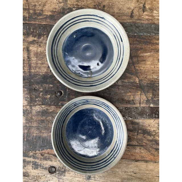 This charming set of two vintage studio pottery bowls showcases rustic elegance with their artisanal craftsmanship. Each...