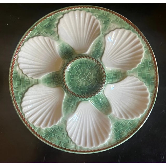 Classic Longchamp green and white oyster plate with shells on a basketweave pattern. The plat has six scallop-shaped wells...