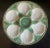 Classic Longchamp green and white oyster plate with shells on a basketweave pattern. The plat has six scallop-shaped wells...
