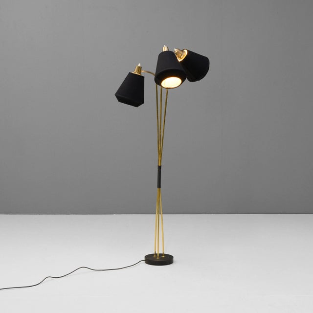 Mid-Century triple stem floor lamp with a steel base and brass stem. The original shades have been re-covered. Fully re-...