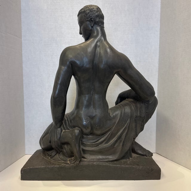 Produced by Austin Productions is a realistic copy of Winifred Turner's Crouching Youth. Plaster sculpture with a...