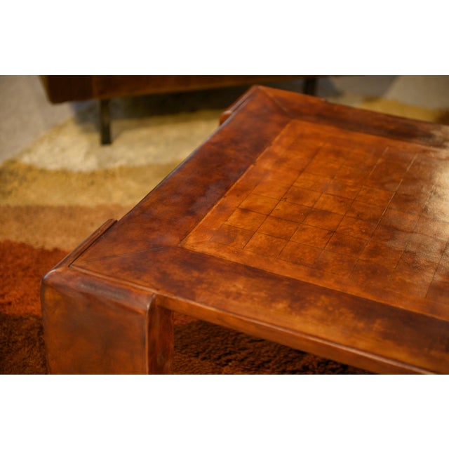 A coffee table with a simple and elegant design, entirely covered in leather with a warm patina.