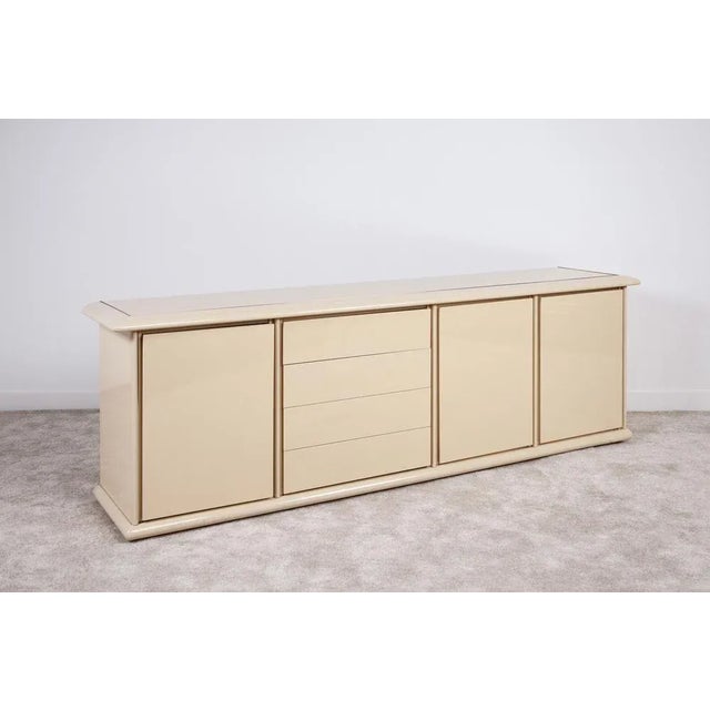 Elegant sideboard-creation in the style of Maison Jansen or Jean Charles, made of lacquered wood finished with brass...