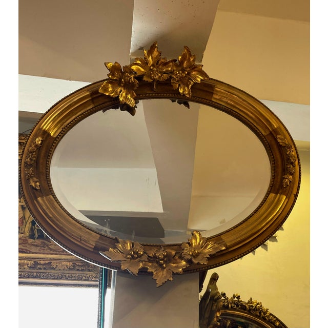 Add timeless European charm to your interior with this beautiful oval wall mirror, featuring a richly detailed frame that...