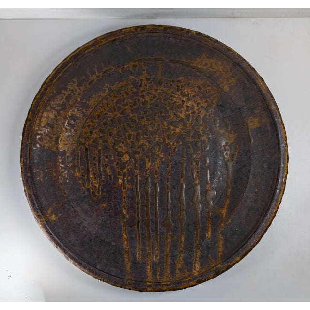 We are selling this Mid-Century Modern Contemporary studio art pottery charger. This Charger has large form with dark...