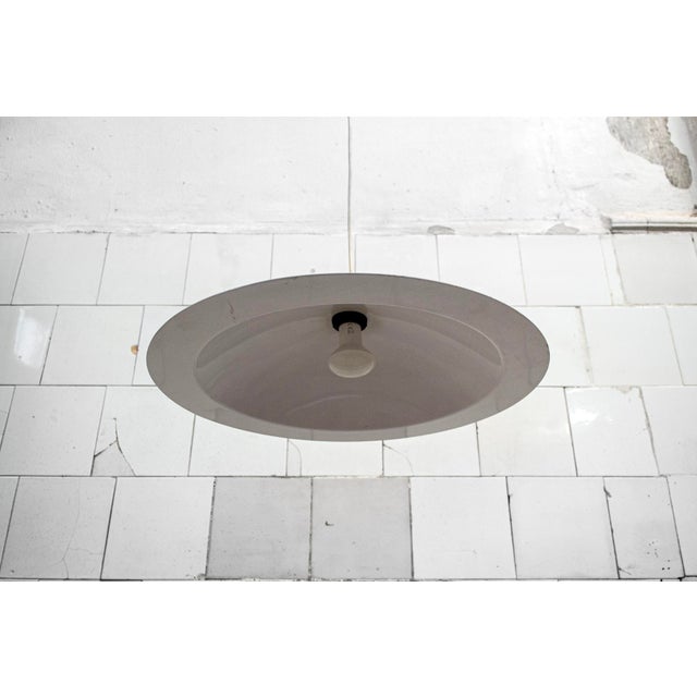 Pendant lamps in green, yellow, and white enameled metal. Lampiatta model Designed by Jonathan De Pas, Donato D'Urbino,...