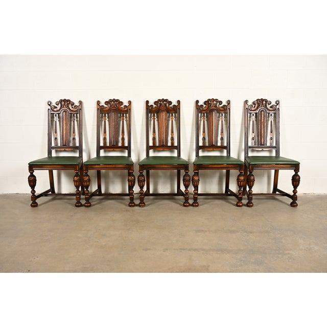 A beautiful set of five antique English Jacobean or Tudor style dining chairs By Berkey & Gay USA, Circa 1920s Carved...