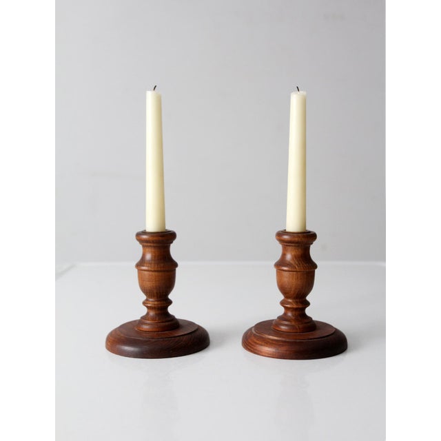 This warm and classic pair of vintage turned wood candlestick holders features traditional proportions and a rich wood...