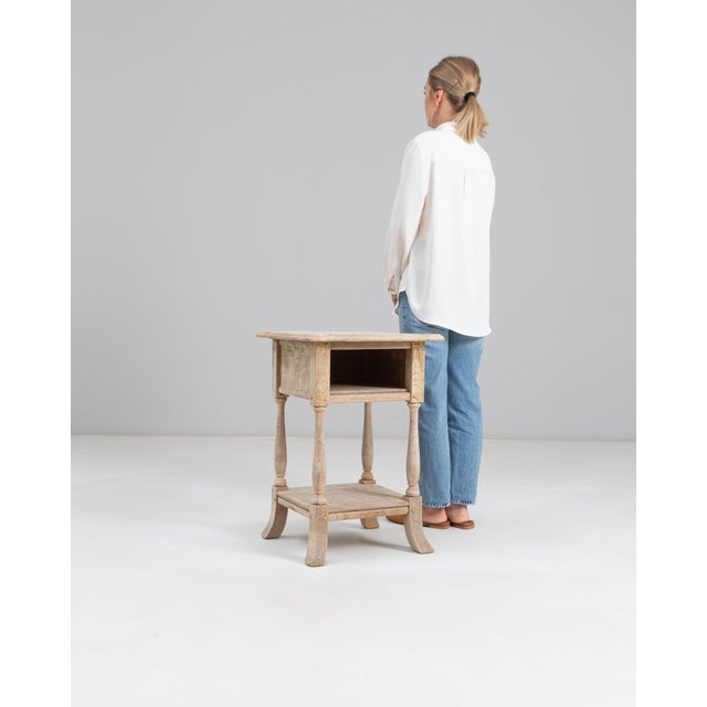 1920s French Oak Side Table. This understated side table reflects early 20th-century French craftsmanship with its simple,...