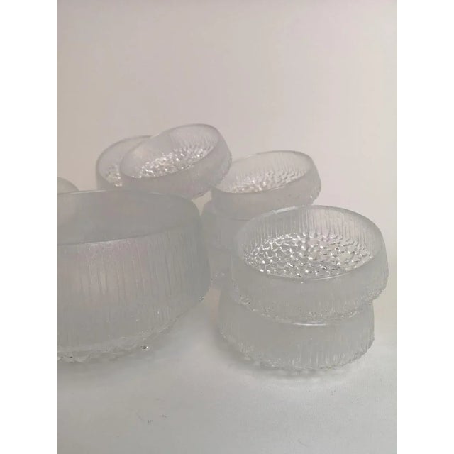 A set of total 13 pieces. 12 clear glass serving bowls and one large bowl in the ultima thule pattern for iittala glass...