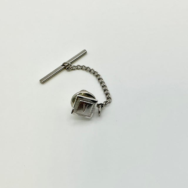 This is a dramatic “V” initial tie clip/tack from the 1950s. We have curated a collection of Mid-Century Cuff Links and...