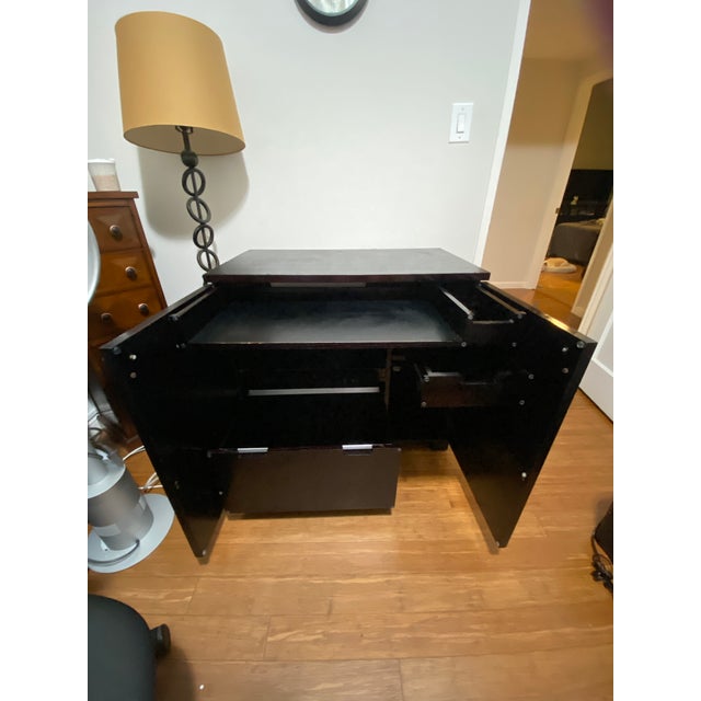 Crate and Barrel Secretary desk circa 2009. This desk appears to be a well structured solid wood cabinet until the doors...