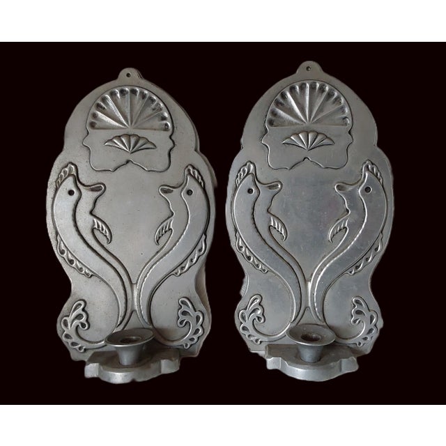 A pair of Vintage Art Deco Style Candle Sconces with Dolphins. The Sconces are made of aluminum metal and have stylized...
