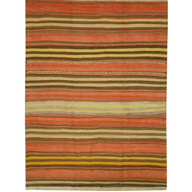 Crafted in the 1950s, this vintage Turkish Kilim is a flat-weave rug handwoven with a blend of simplicity and boldness....