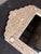 Bohemian-inspired arched mirror featuring an ivory frame with intricate gold botanical detailing and star accents. The...