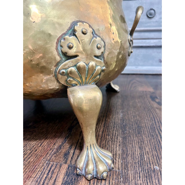 Large antique English brass log bin or jardinière with beautifully aged hand-hammered surface, decorative clover-form...