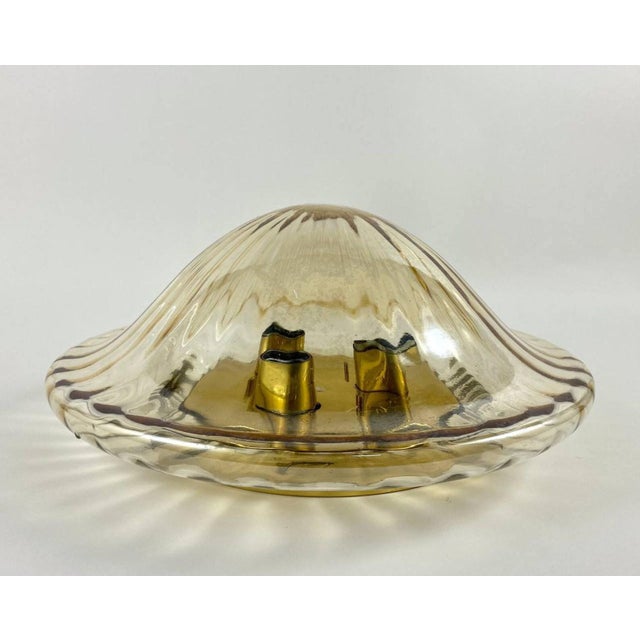 Vintage flush mount chandelier with 3 light points. Corrugated glass shade. This chic ceiling lamp has a gilt brass...