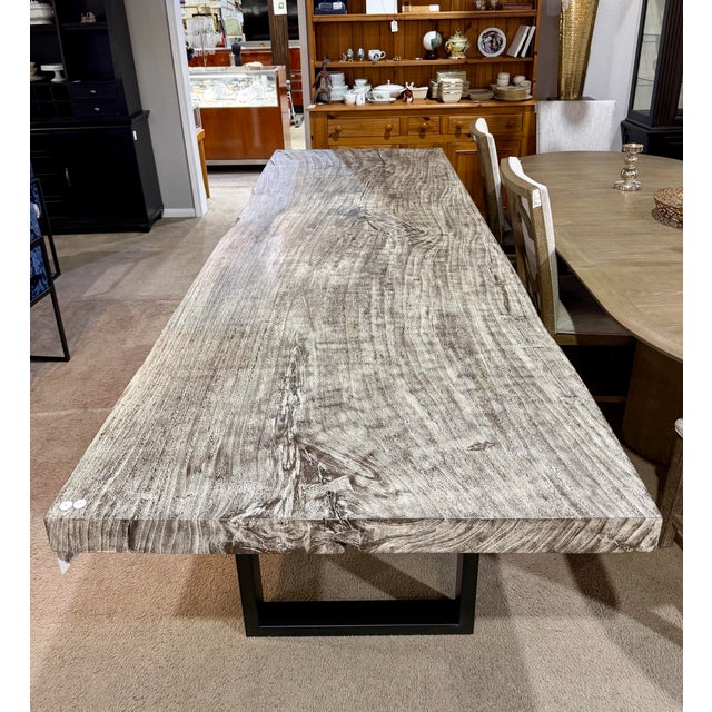 A sophisticated dining table from Origins by Phillips Collection, featuring a sleek straight-edge silhouette and a...
