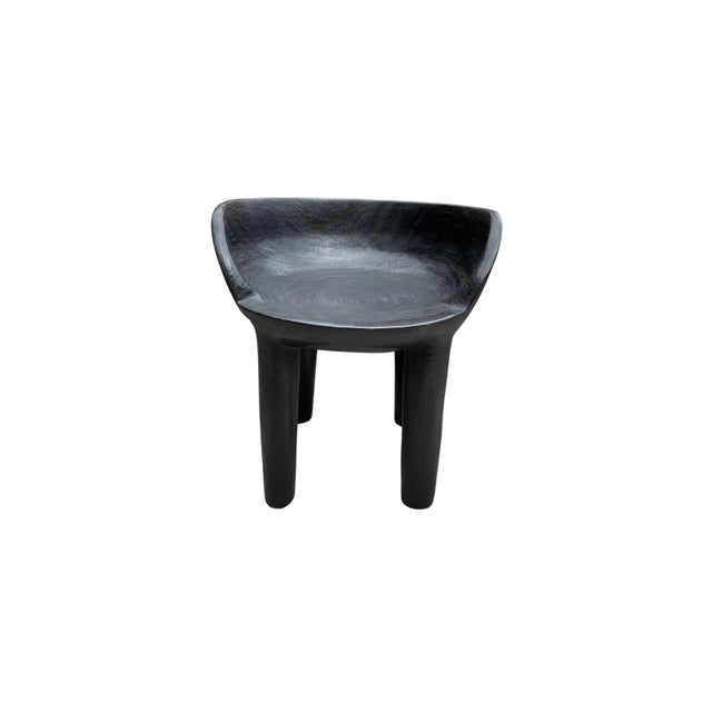 This wonderfully sculptural chair was crafted from a single block of mango wood. The chair sits on 4 slender legs. Its...