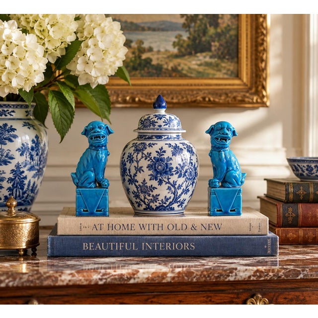 A wonderfully decorative pair of mid-20th century porcelain guardian lions, or foo dogs, finished in a vivid turquoise...
