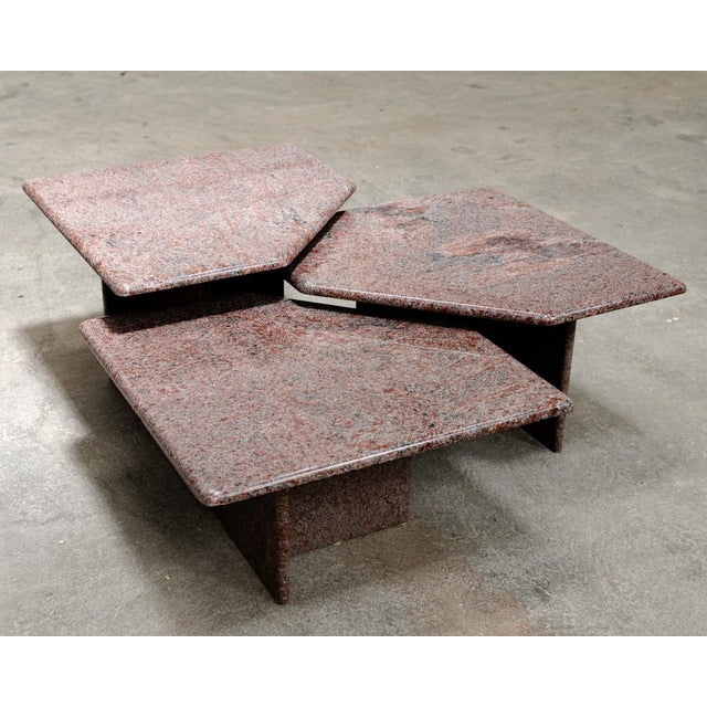 A beautiful set of three vintage nesting tables in pink granite from the 1970s. We love their geometric lines, softened...