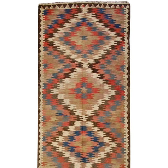 An early 20th Century Persian Kilim runner with wonderful zigzag woven diamond pattern of alternating crimson, white,...