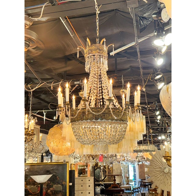 This Early 19th century French Empire Basket Chandelier features a stunning Greek Key Motif design, adding a touch of...