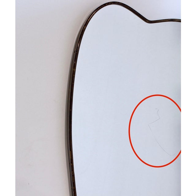 Mid-century italian wall mirror with brass frame (circa 1960s). The mirror is classically-shaped and distinctive in a...