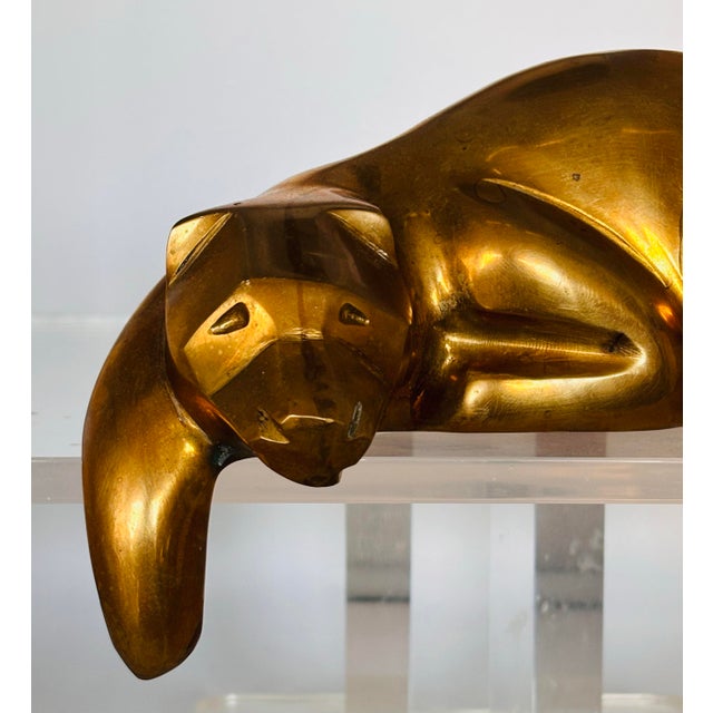 A 1980’s suave and sexy Dolbi Cashier brass resting panther. Crafted in solid brass and shaped like a piece of three-...