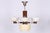 This 4-arm chandelier is a masterpiece of 1920s Czechoslovak Art Deco. The lighting fixture presents a fascinating...