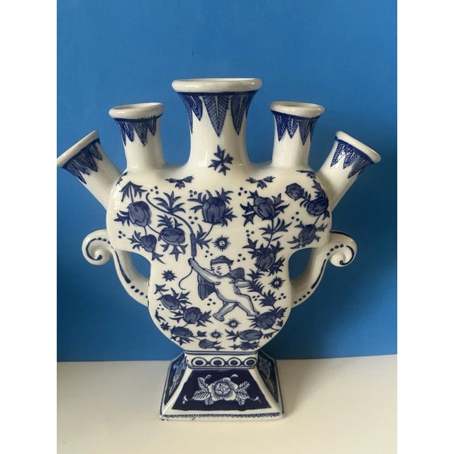 Elegant vintage Chinoiserie tulip vase crafted from fine porcelain and beautifully hand-painted in classic blue and white....