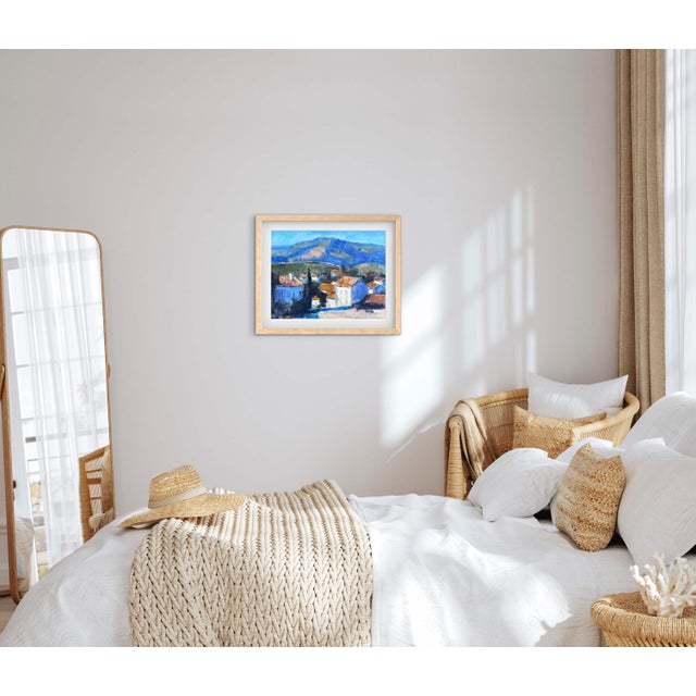 Village Below the Blue Mountain captures the quiet charm of a hillside village nestled beneath sweeping blue mountains....