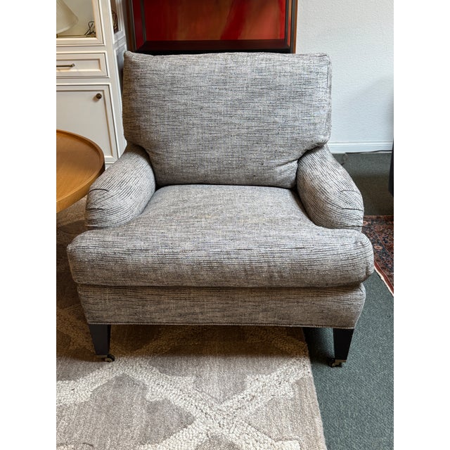 Design Plus Gallery presents Essex Lounge Armchair from Crate & Barrel. The chair has gray textured woven upholstery with...