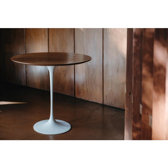 Rare 1960s Saarinen Oval Walnut Table with Early Knoll Label. Executed in beautifully grained walnut and enameled metal...