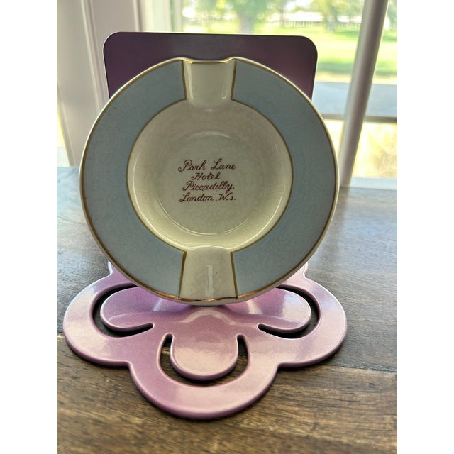 Add a touch of Mayfair glamour to your tabletop with this exceptional vintage porcelain vide-poche and ashtray from...