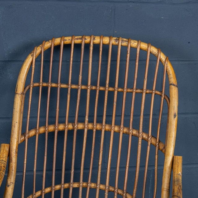 A striking pair of wicker armchairs by renowned italian designer tito agnoli that encapsulate the elegance and natural...